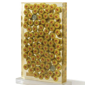 ARMAN Inclusion of Tuborg beer bottle caps in resin, signed and numbered 20/30, with a brass plate embedded in the resin